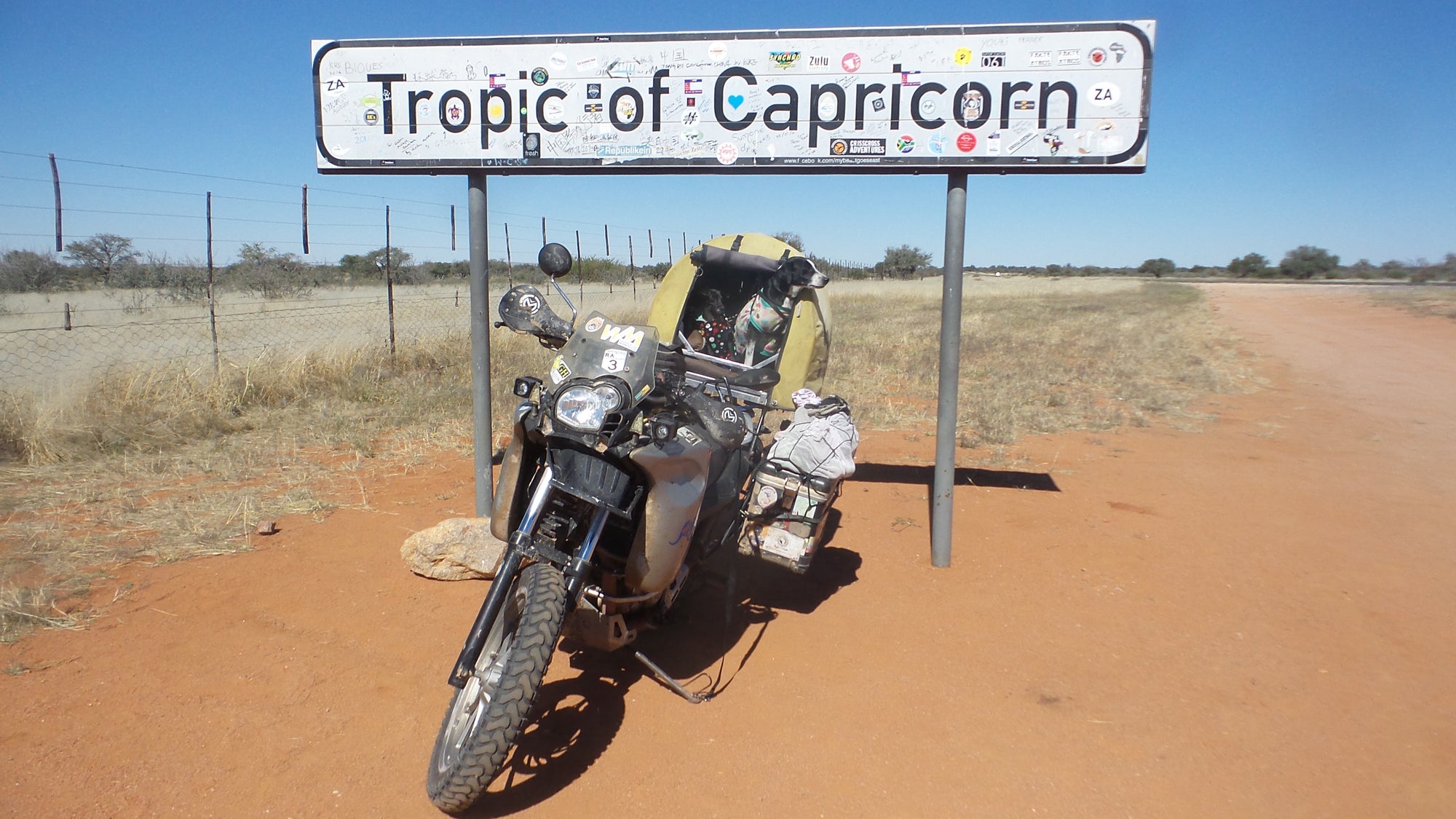 The Pack Track crossed the Tropic of Capricorn, Namibia. Weeti and Shadow were so excited about getting a photo in their Pillion Pooch under the sign.